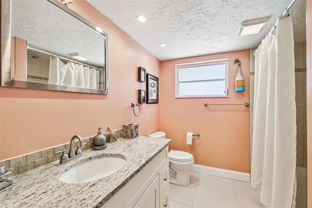 an empty room with fireplace and windows