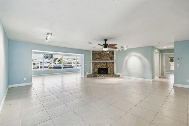 a bathroom with a granite countertop sink a mirror and shower