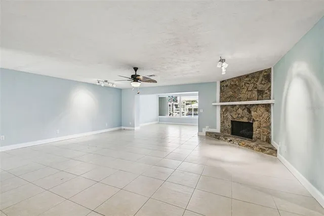 a kitchen with stainless steel appliances granite countertop a sink a stove top oven and white cabinets