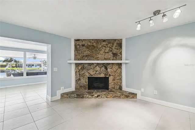 a view of a living room with hardwood floor and a large window