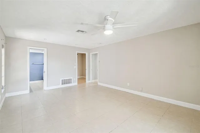 a living room with furniture and a view of kitchen