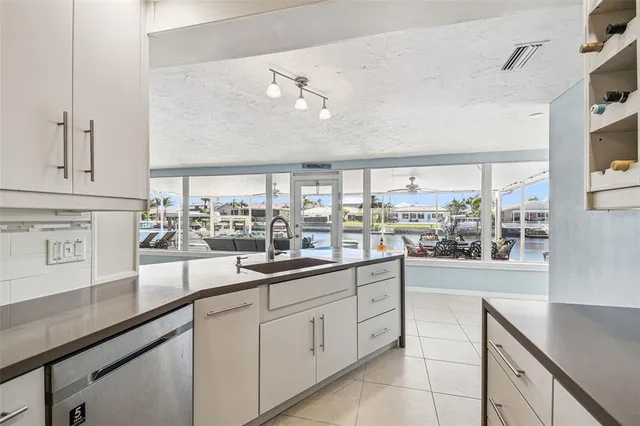 an aerial view of a house with a yard lake view and mountain view