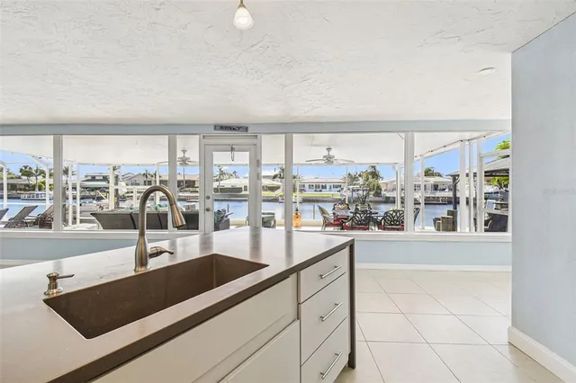 an aerial view of a house with a garden and lake view