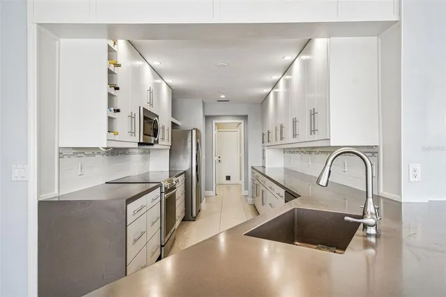 an aerial view of residential houses with outdoor space and swimming pool