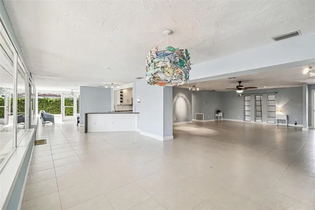 an aerial view of residential houses with outdoor space and a lake view