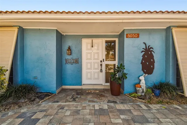 an empty room with ceiling fan and window