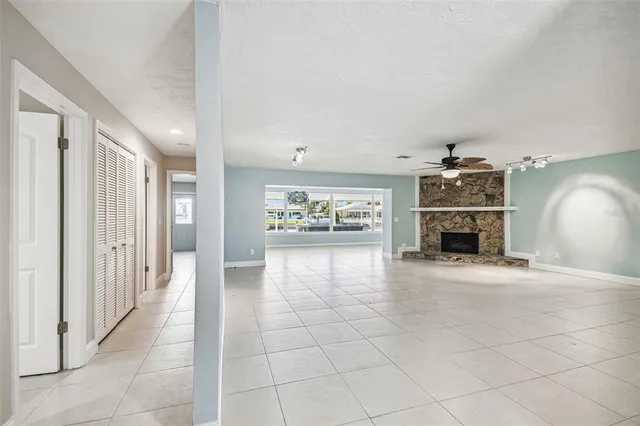 a bathroom with a granite countertop sink a mirror and shower