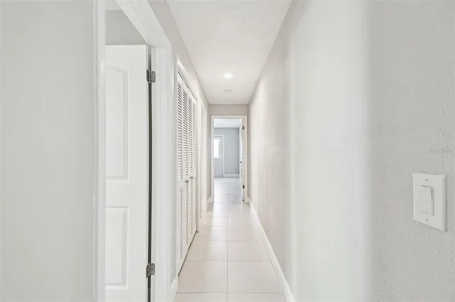 an empty room with a ceiling fan and a window
