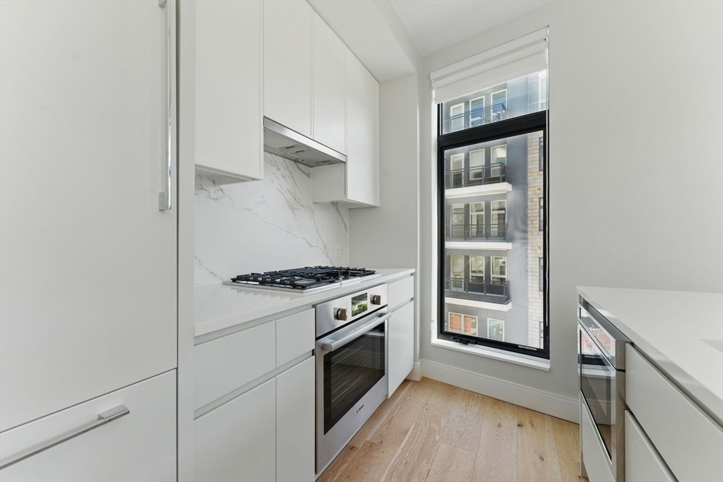 191 Washington Street, Unit 524 Boston, MA 02135 - Photo 11 of 42 a kitchen with stainless steel appliances a stove and a refrigerator