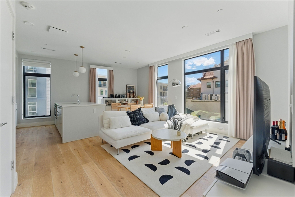 191 Washington Street, Unit 524 Boston, MA 02135 - Photo 2 of 42 a living room with furniture and a table