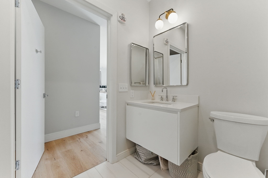 191 Washington Street, Unit 524 Boston, MA 02135 - Photo 25 of 42 a bathroom with a sink a toilet and shower