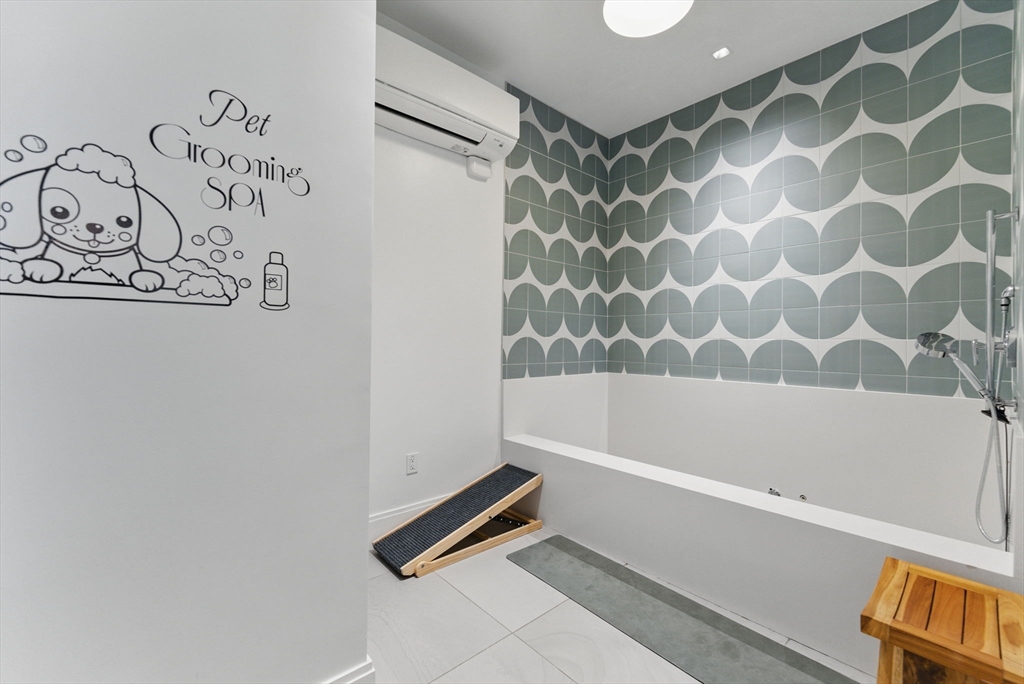191 Washington Street, Unit 524 Boston, MA 02135 - Photo 40 of 42 a bathroom with a bathtub and a shower