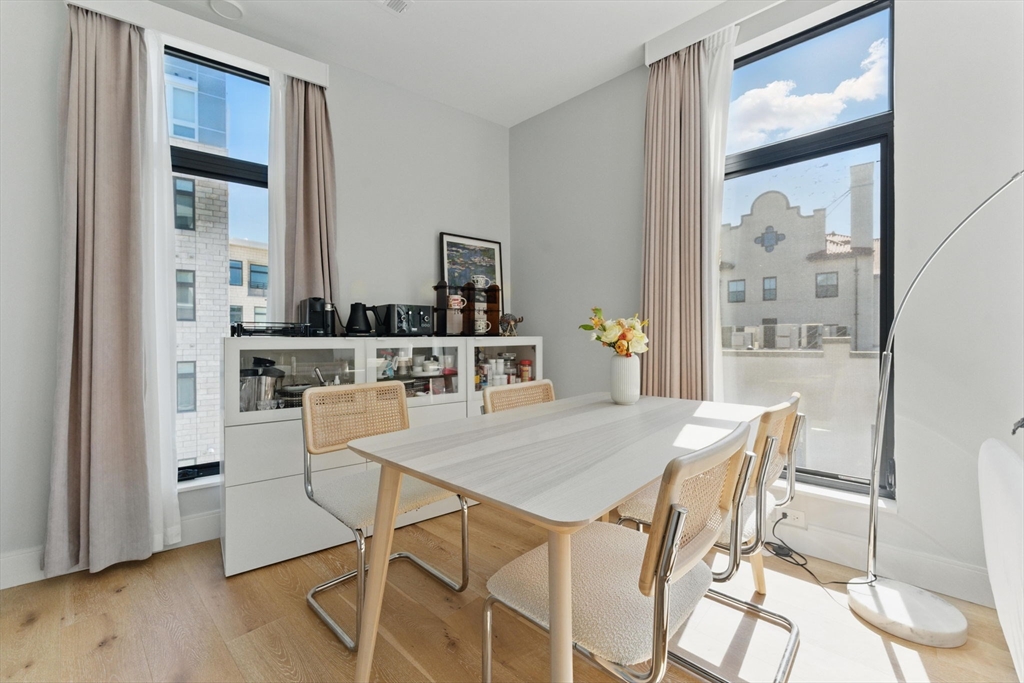 191 Washington Street, Unit 524 Boston, MA 02135 - Photo 6 of 42 a view of a dining room with furniture and wooden floor