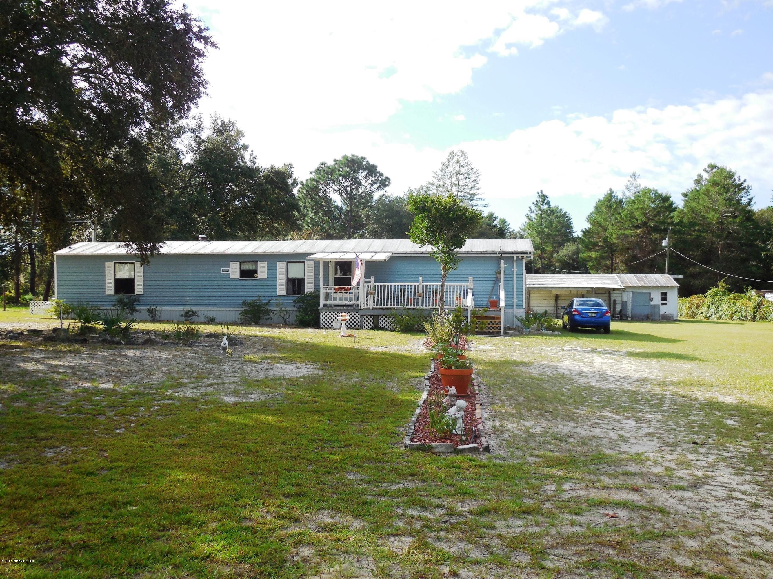 105 Ketner Road Welaka, FL 32112 - Photo 1 of 34 a view of a house with a swimming pool
