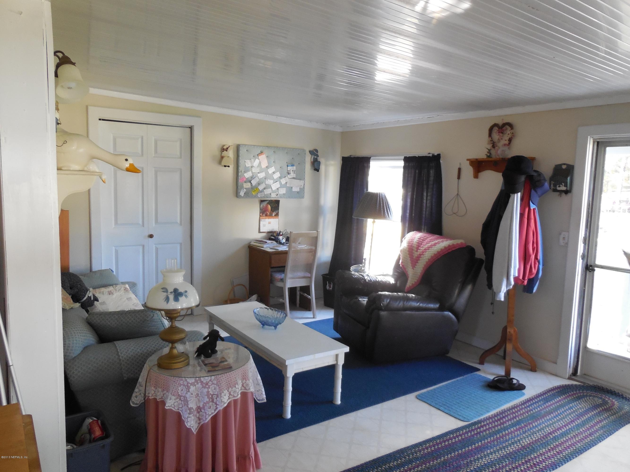 105 Ketner Road Welaka, FL 32112 - Photo 14 of 34 a living room with furniture a window and a flat screen tv