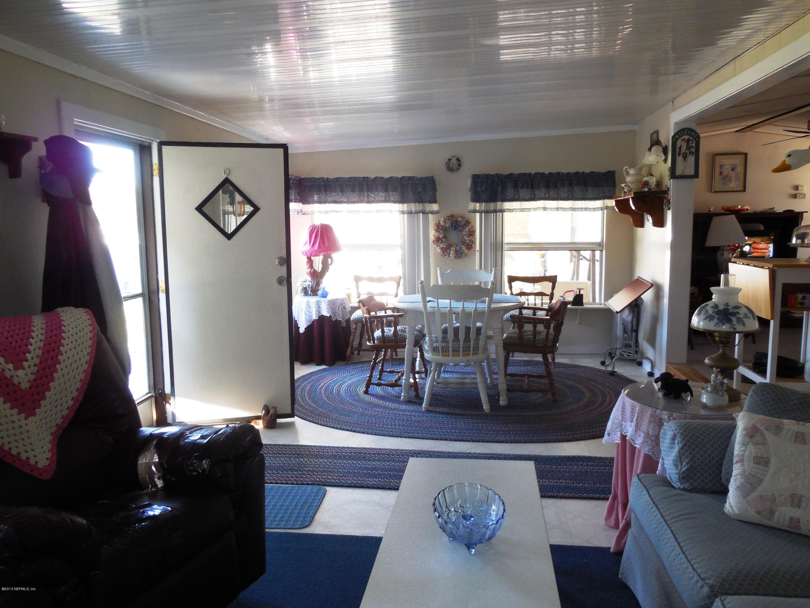 105 Ketner Road Welaka, FL 32112 - Photo 15 of 34 a living room with furniture and wooden floor