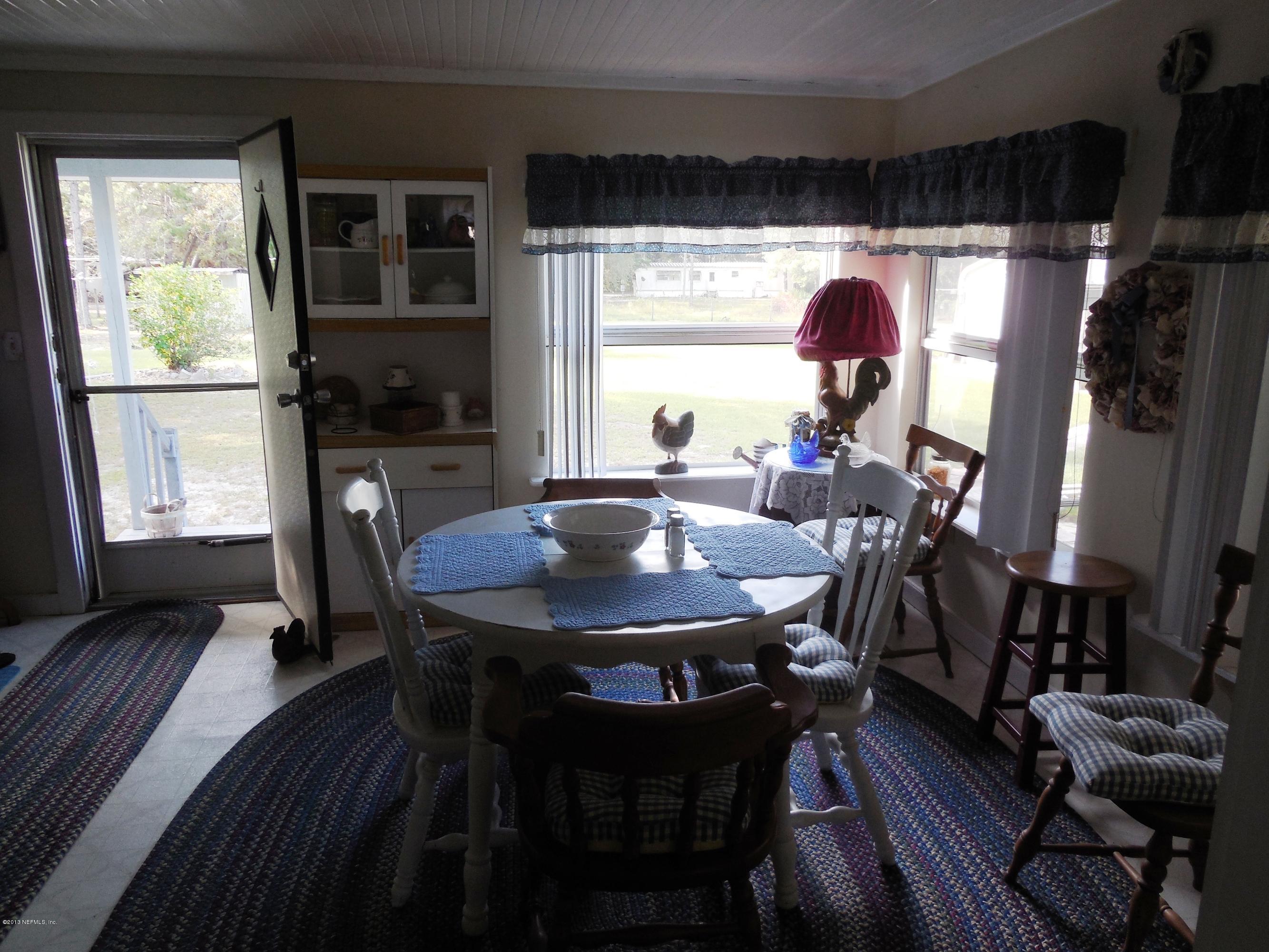 105 Ketner Road Welaka, FL 32112 - Photo 16 of 34 a view of a dining room with furniture window and outside view