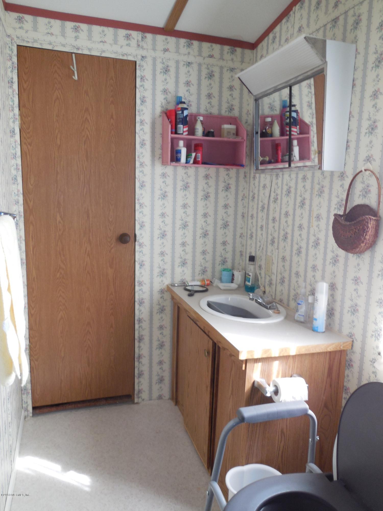 105 Ketner Road Welaka, FL 32112 - Photo 20 of 34 a room with stainless steel appliances a sink and a refrigerator