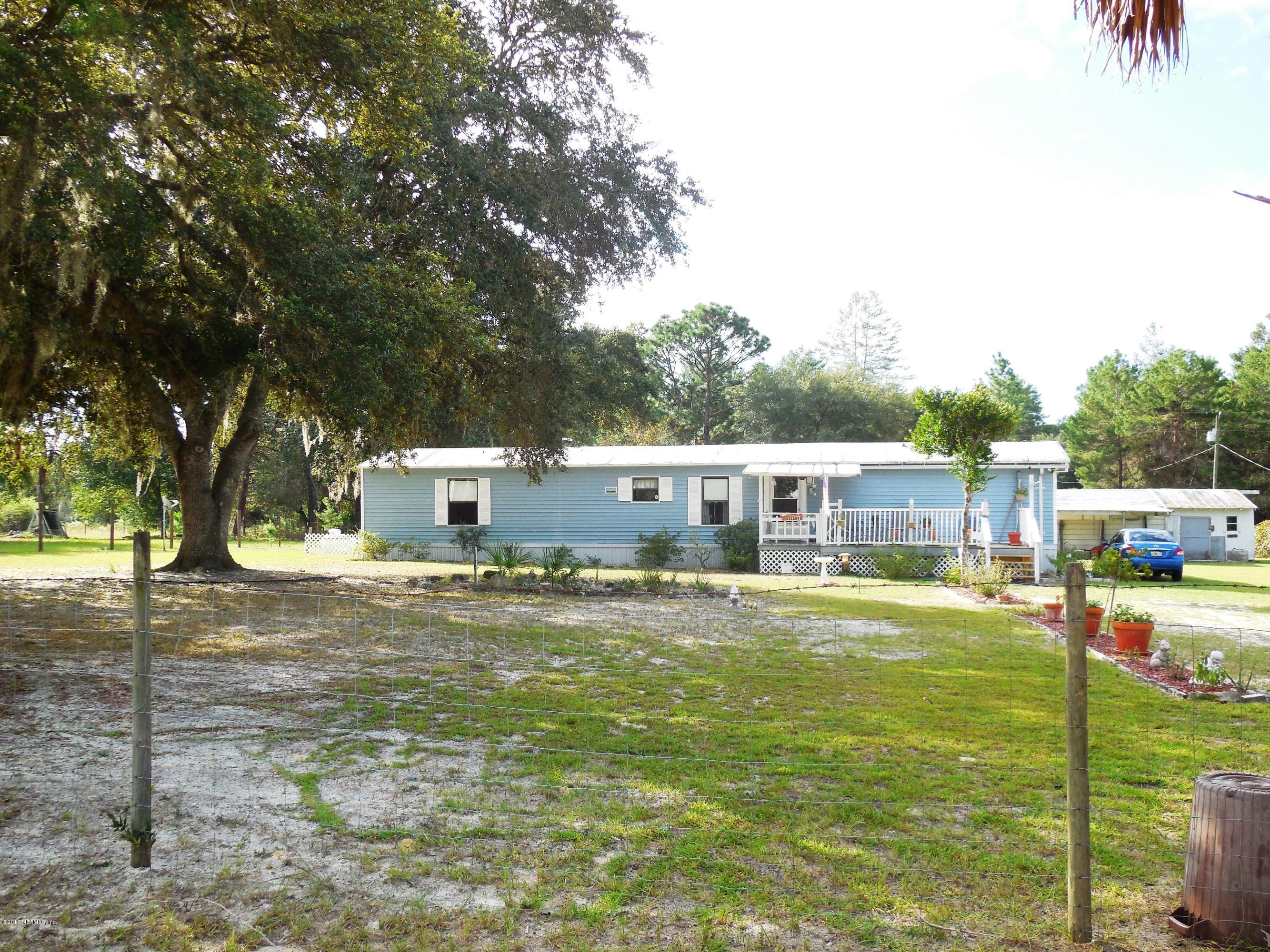 105 Ketner Road Welaka, FL 32112 - Photo 2 of 34 a house view with a sitting space and garden space