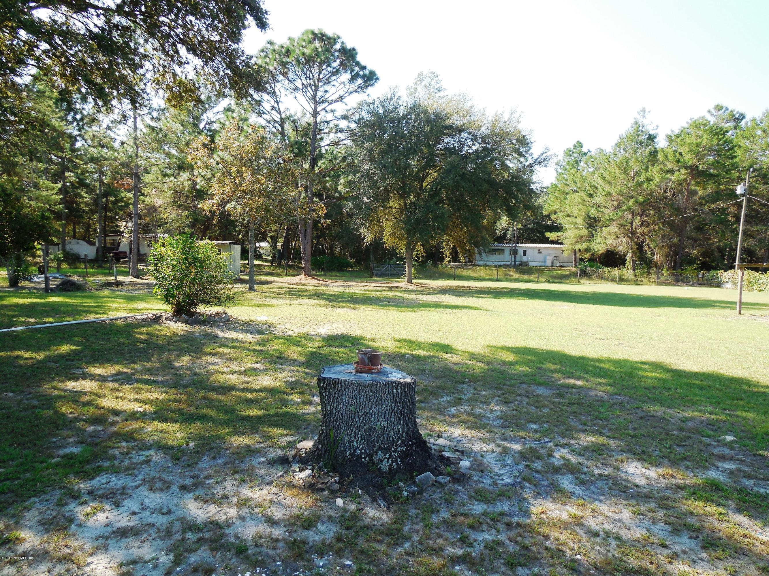 105 Ketner Road Welaka, FL 32112 - Photo 25 of 34 a view of a swimming pool with a yard and sitting area