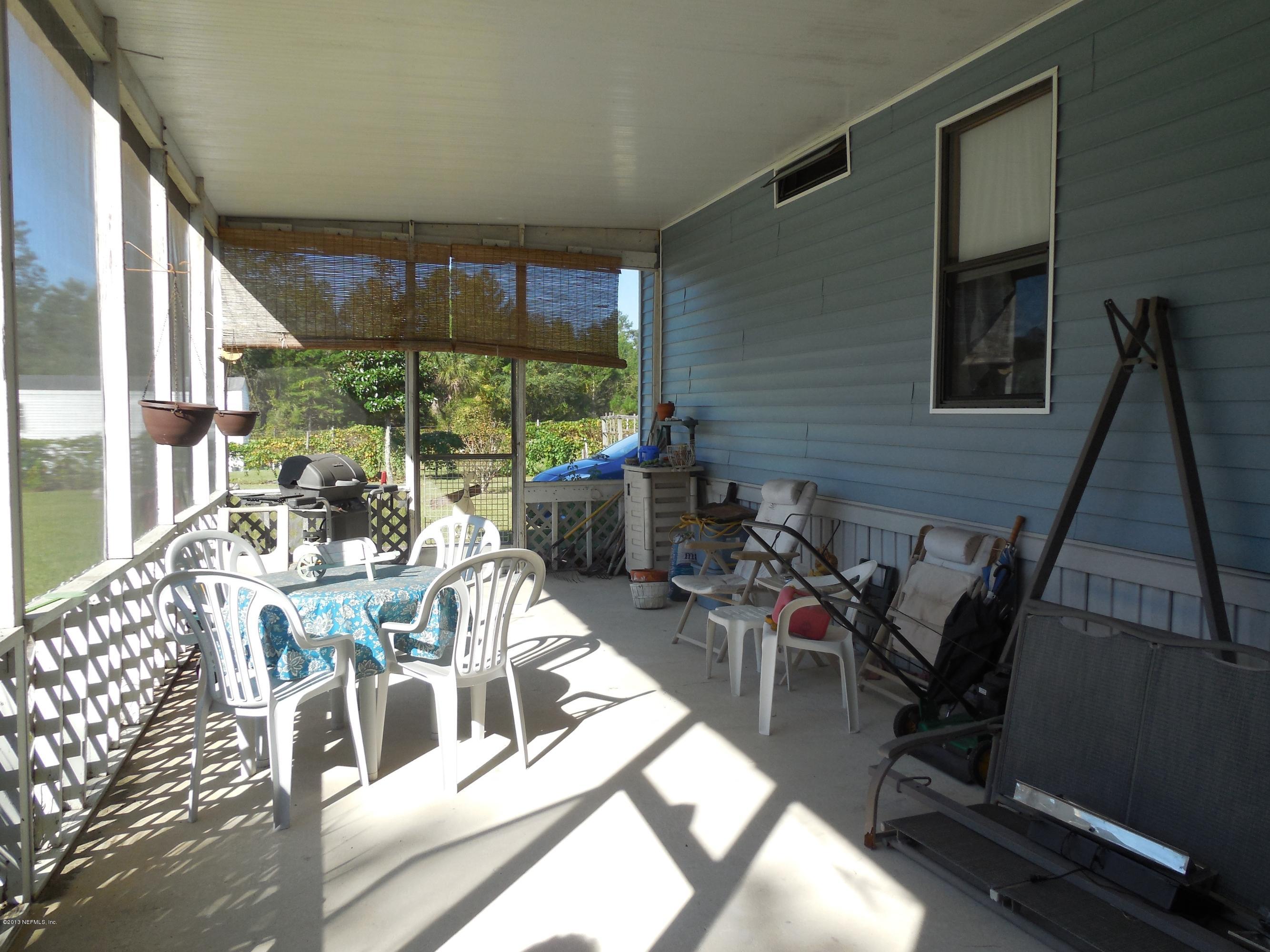 105 Ketner Road Welaka, FL 32112 - Photo 26 of 34 a view of a dining room with furniture window and outside view
