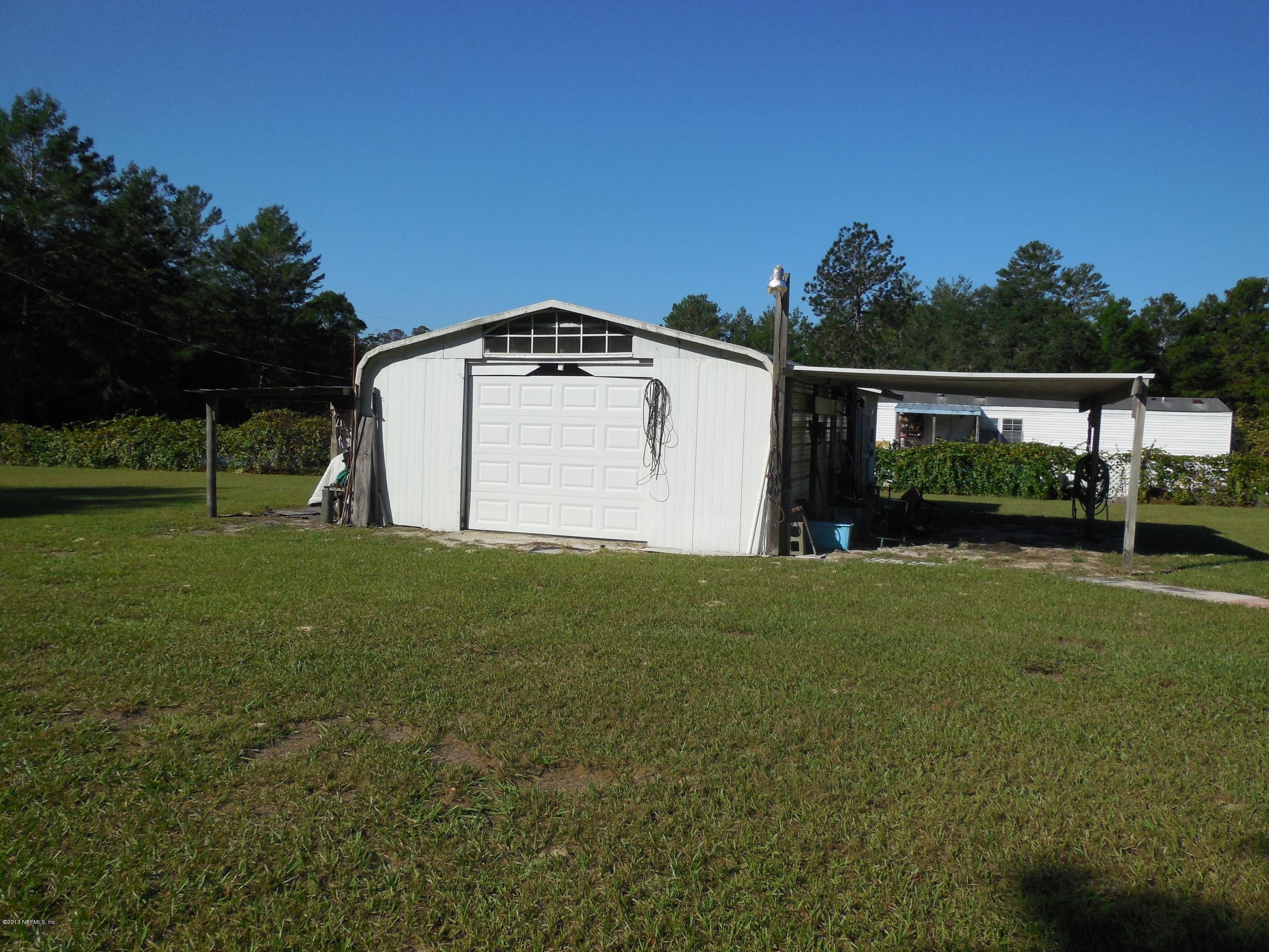 105 Ketner Road Welaka, FL 32112 - Photo 29 of 34 a house with green field in front of it
