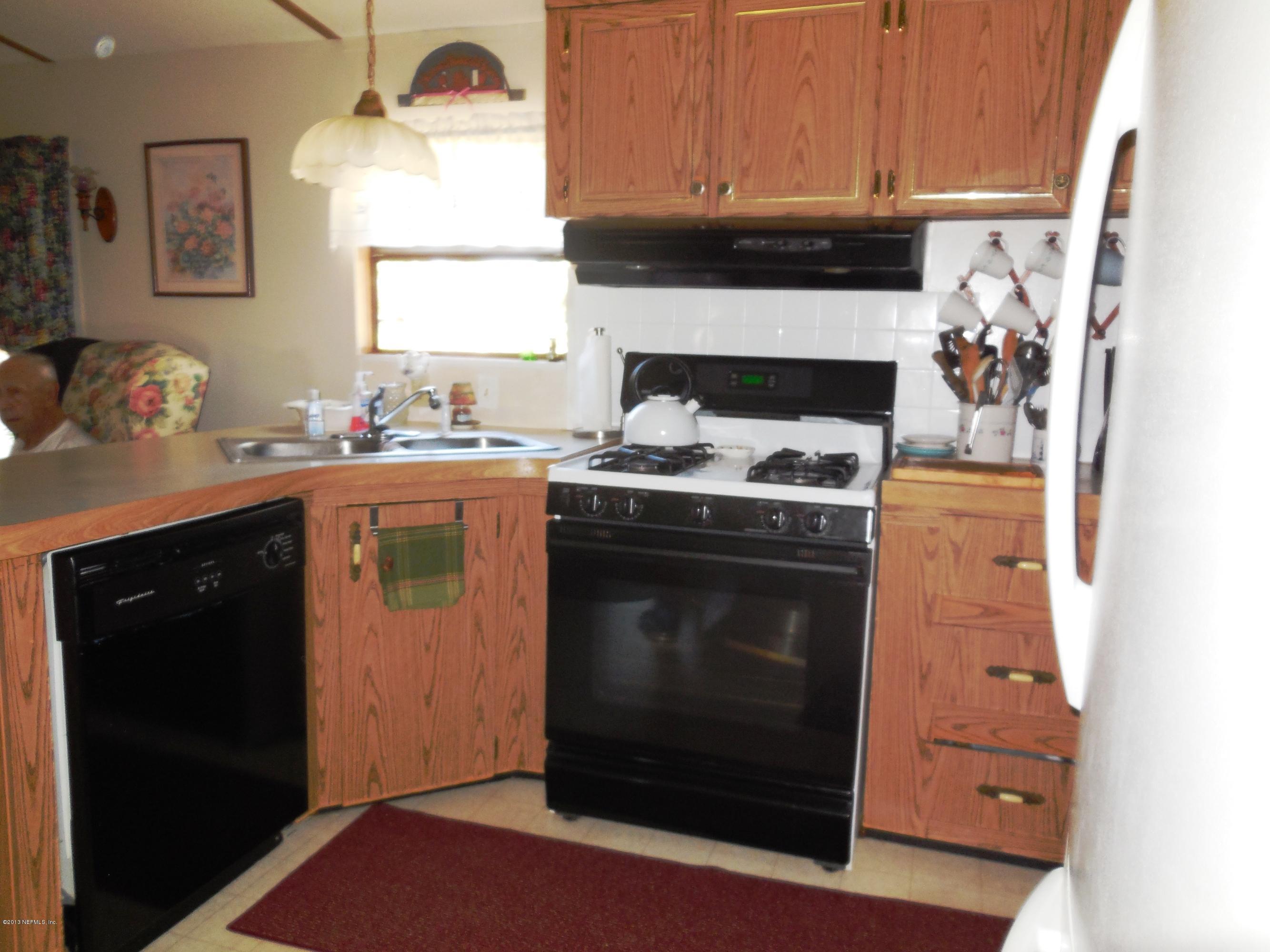 105 Ketner Road Welaka, FL 32112 - Photo 10 of 34 a kitchen with a stove and a microwave