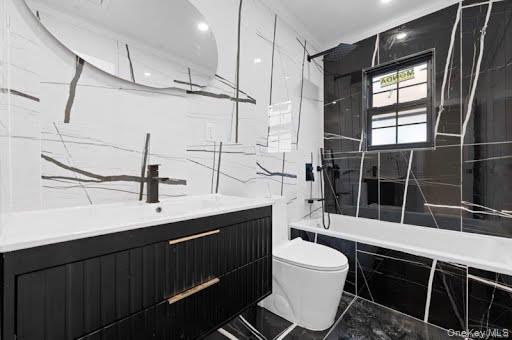 249-17 147th Road, Unit 1 Queens, NY 11422 - Photo 10 of 13 Modern bathroom featuring a black vanity with gold-tone hardware, a rectangular built-in sink, and a wall-mounted matte black faucet