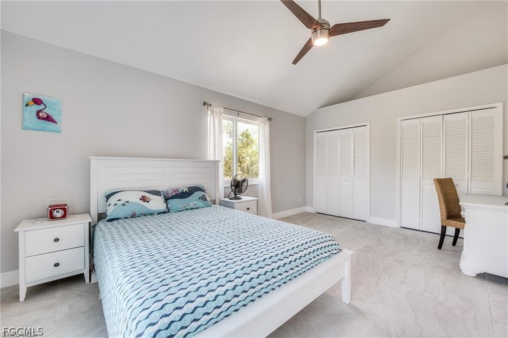 785 Rabbit Road Sanibel, FL 33957 - Photo 18 of 32 a bedroom with a bed and large windows
