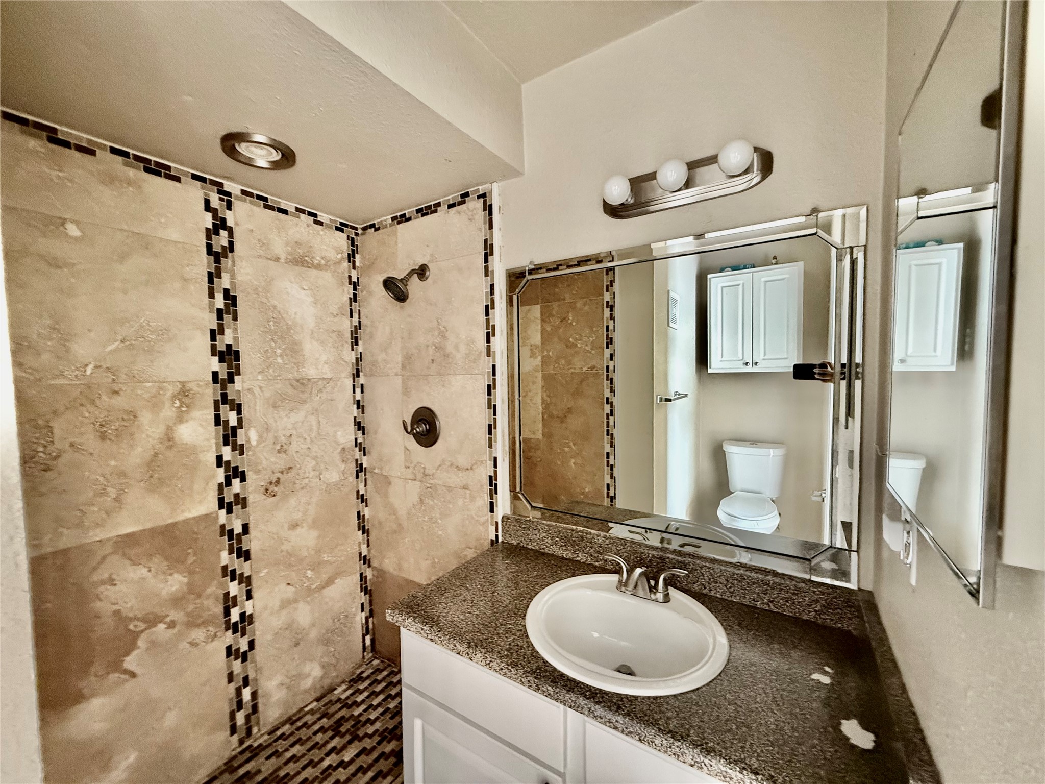 2018 West Rundberg Lane, Unit 6A Austin, TX 78758 - Photo 14 of 17 Full bathroom featuring vanity and tiled shower