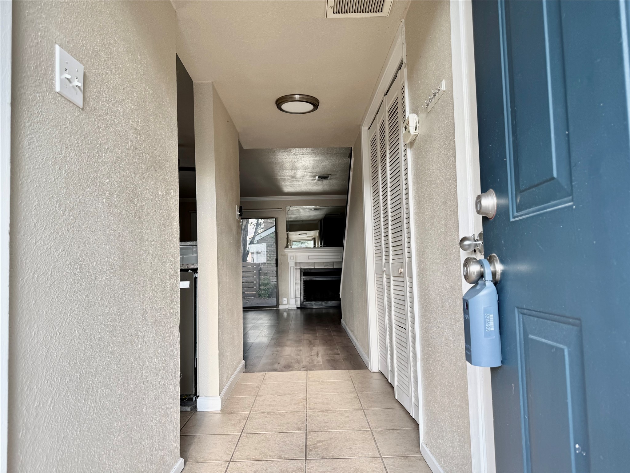2018 West Rundberg Lane, Unit 6A Austin, TX 78758 - Photo 4 of 17 Corridor with a textured wall and light tile patterned floors