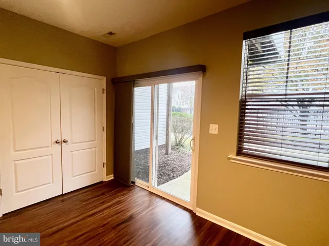 a view of wooden floor and windows in a room