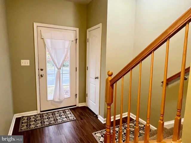 a view of an entryway with wooden floor
