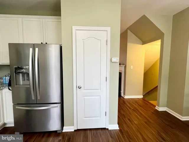 a metallic refrigerator freezer sitting in a kitchen