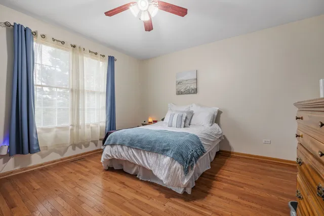 a spacious bedroom with a bed and a chandelier