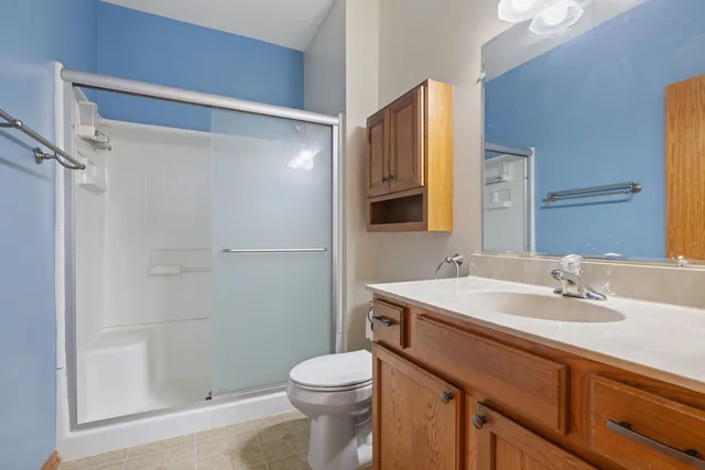 a bedroom with a bed and a desk