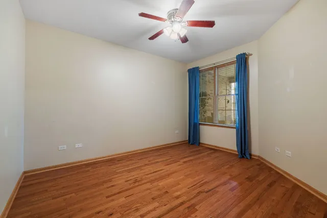 a bathroom with a granite countertop toilet sink and mirror