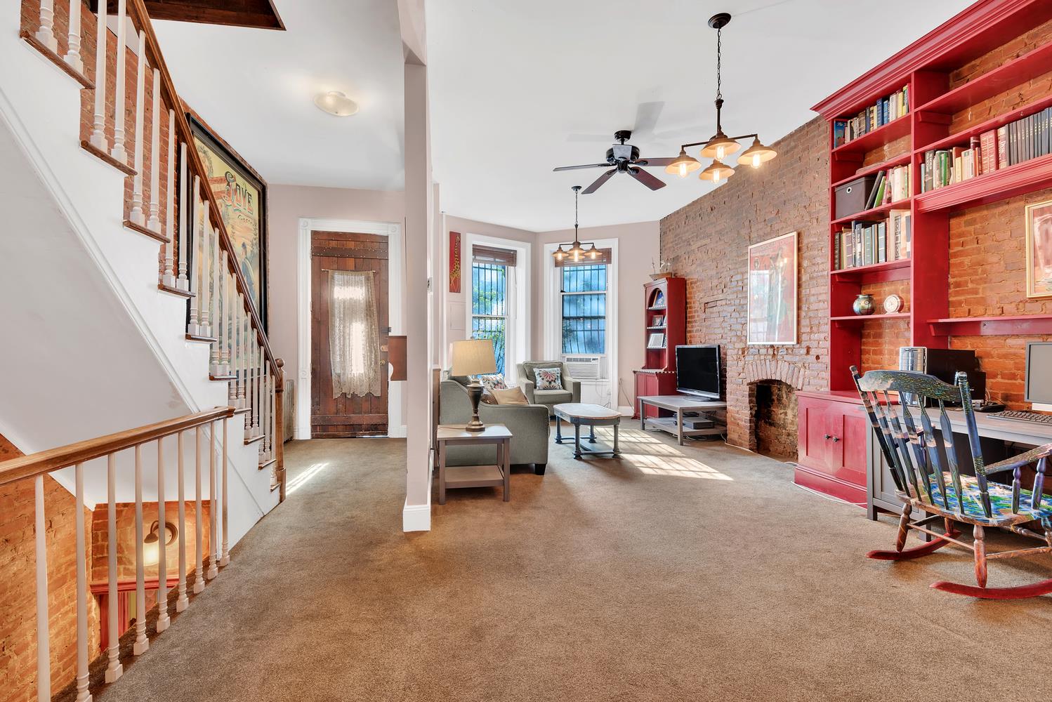 a living room with furniture a fireplace and a chandelier