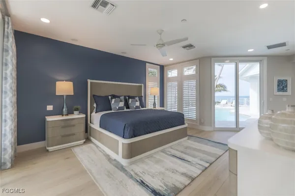 a bedroom with a large bed and a large window