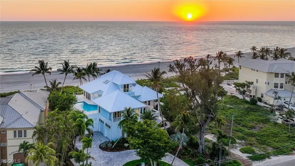 an aerial view of house with ocean view