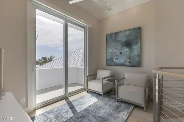 a living room with furniture and a floor to ceiling window