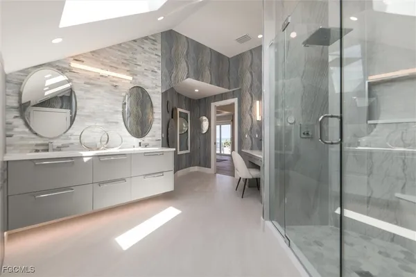 a bathroom with a double vanity sink and mirror