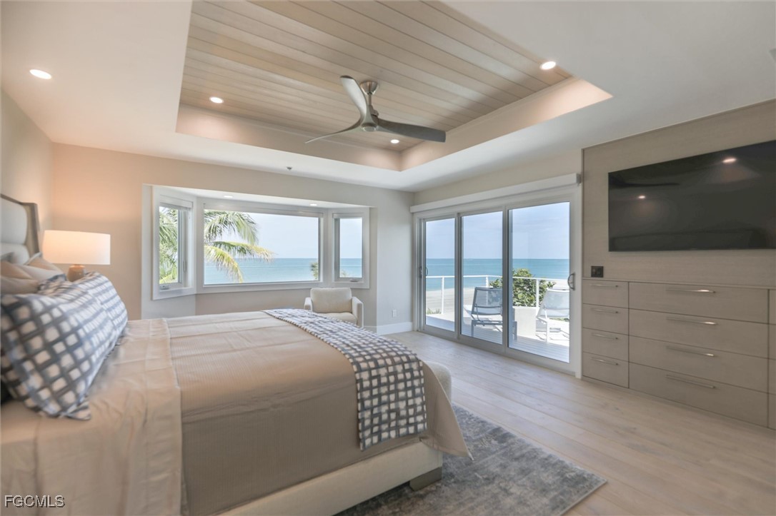 941 South Seas Plantation Road Captiva, FL 33924 - Photo 29 of 50 a bedroom with a large bed and a flat tv screen on dresser