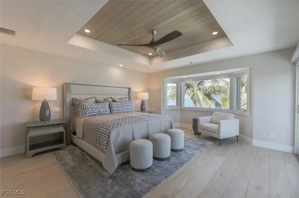 a bedroom with bed and wooden floor