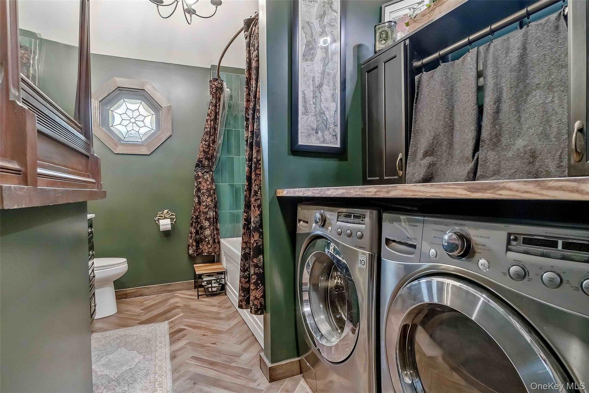 27 West 11th Road Queens, NY 11693 - Photo 7 of 18 Laundry room featuring washing machine and dryer and baseboards