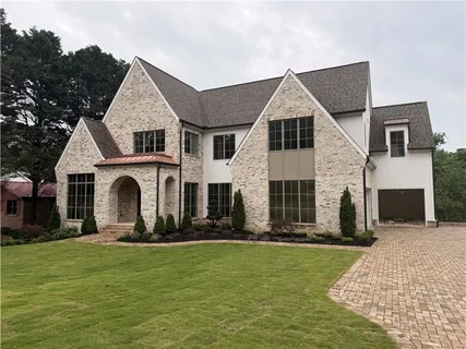 a front view of house with yard and green space