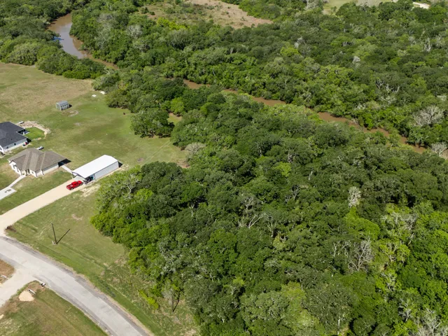 a view of a green yard with a small pool