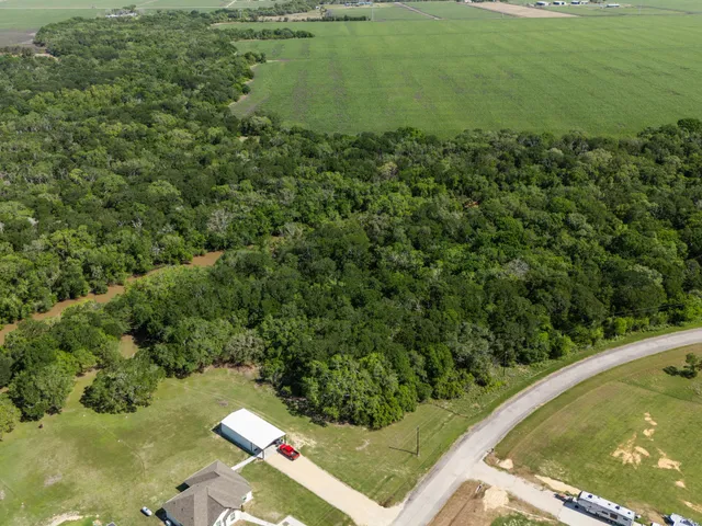 an aerial view of a house with yard and outdoor seating