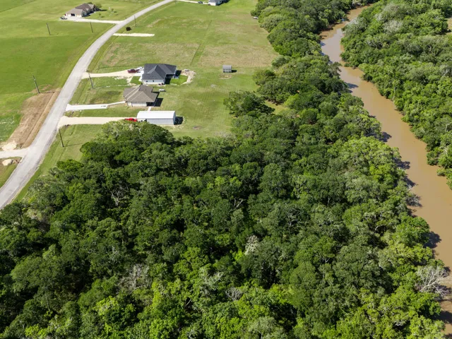 an aerial view of a house with yard and outdoor seating