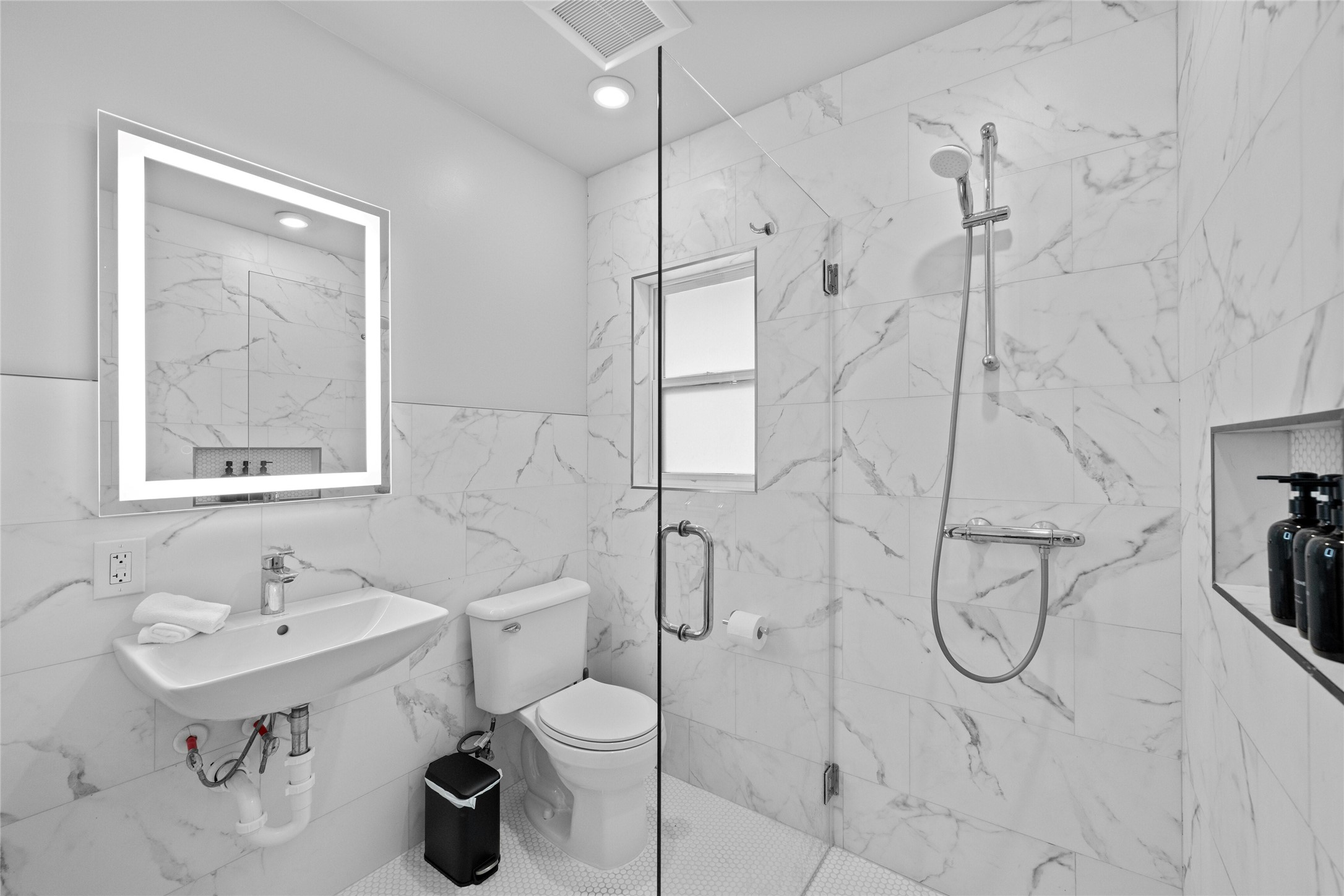 2201 Leon Street, Unit D Austin, TX 78705 - Photo 19 of 24 Bathroom with sink, toilet, and an enclosed shower